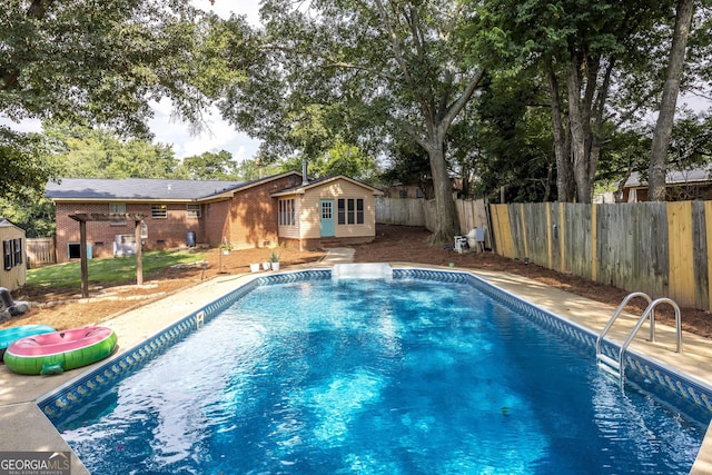 view of pool featuring an outbuilding