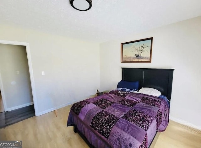 bedroom with hardwood / wood-style flooring