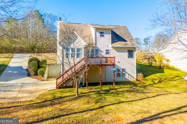 back of house with a yard and a deck