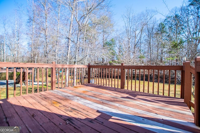 wooden deck featuring a yard