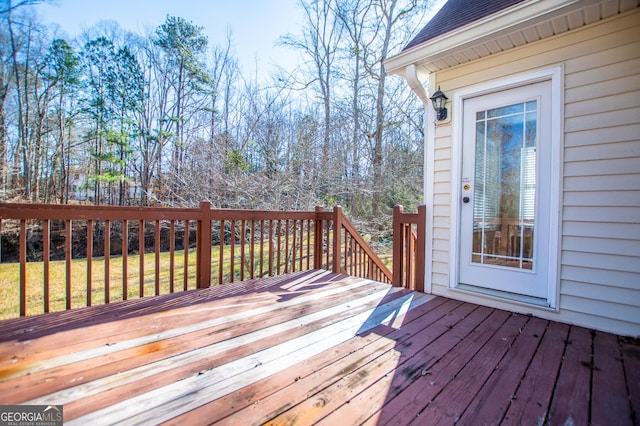 wooden terrace featuring a yard