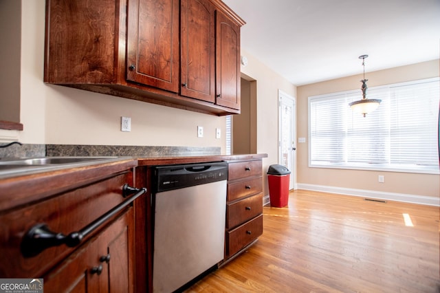 kitchen featuring stainless steel dishwasher, light hardwood / wood-style floors, and hanging light fixtures