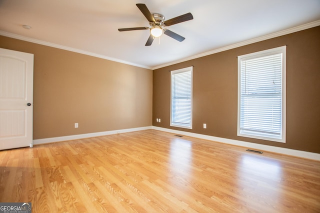 spare room with crown molding, ceiling fan, and light wood-type flooring