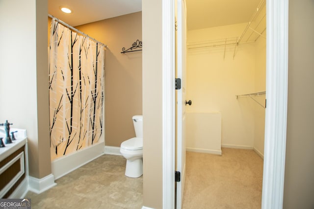 bathroom featuring toilet and walk in shower