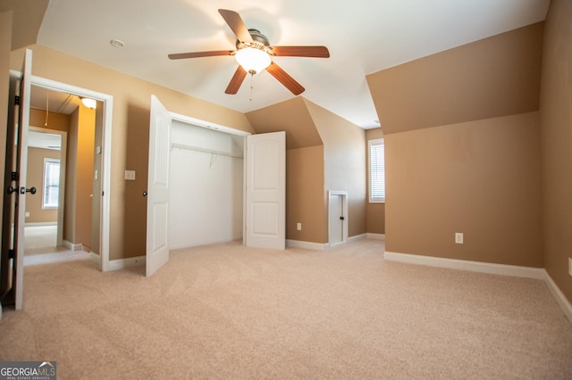 bonus room with ceiling fan, light carpet, and vaulted ceiling