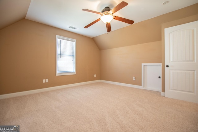 bonus room featuring ceiling fan, light carpet, and vaulted ceiling