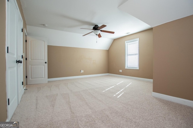 bonus room featuring ceiling fan, light colored carpet, and vaulted ceiling