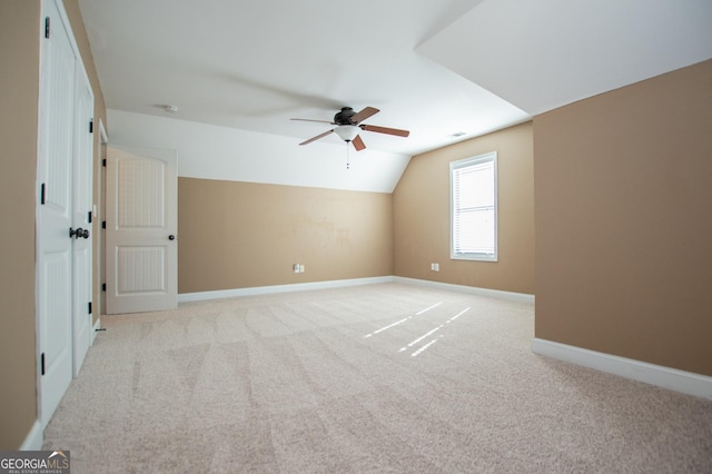 bonus room featuring ceiling fan, light carpet, and vaulted ceiling