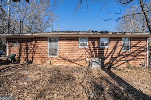 back of house with central AC unit