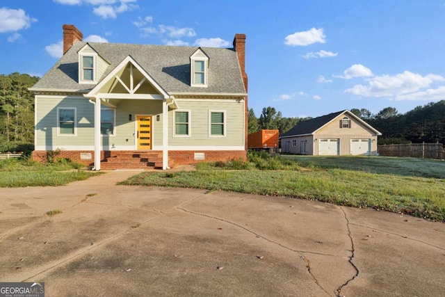 cape cod home with a front yard, covered porch, an outdoor structure, and a garage