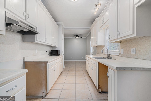 kitchen featuring white cabinets, ceiling fan, light tile patterned floors, and sink