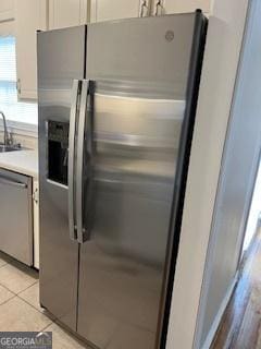 kitchen featuring light tile patterned floors, light countertops, and appliances with stainless steel finishes