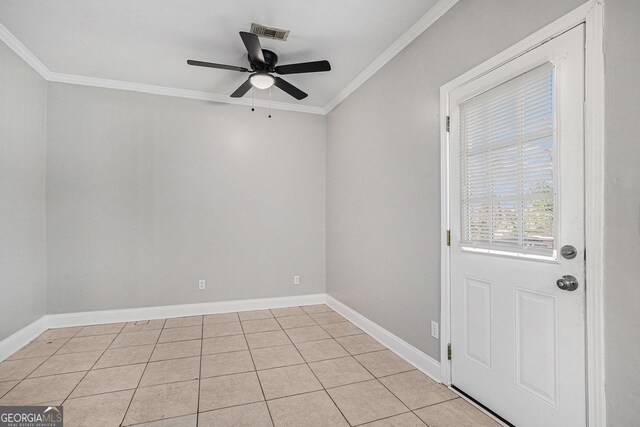 empty room featuring ornamental molding, light tile patterned flooring, baseboards, and a ceiling fan