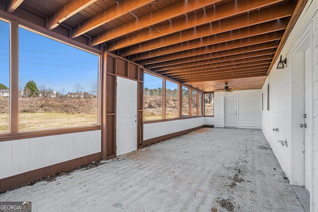 rear view of property featuring a sunroom, cooling unit, and a lawn