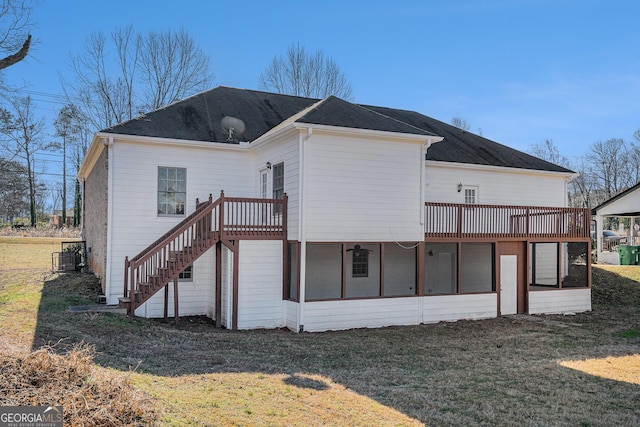 rear view of property with stairs, a yard, and central AC