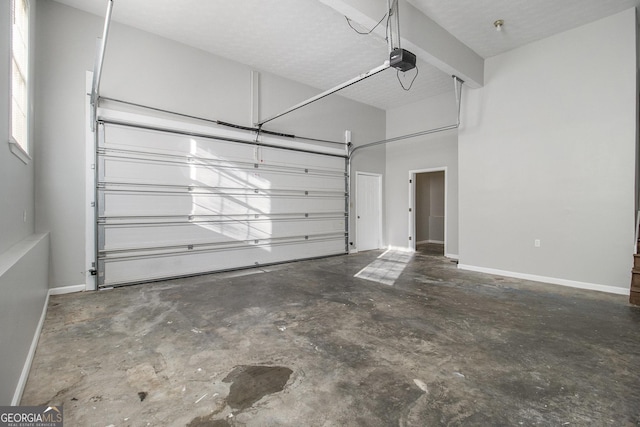 garage with baseboards and a garage door opener