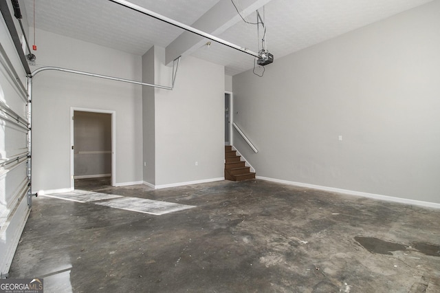 garage with baseboards and a garage door opener