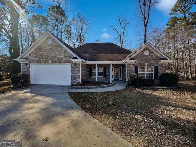 single story home with a porch and a garage