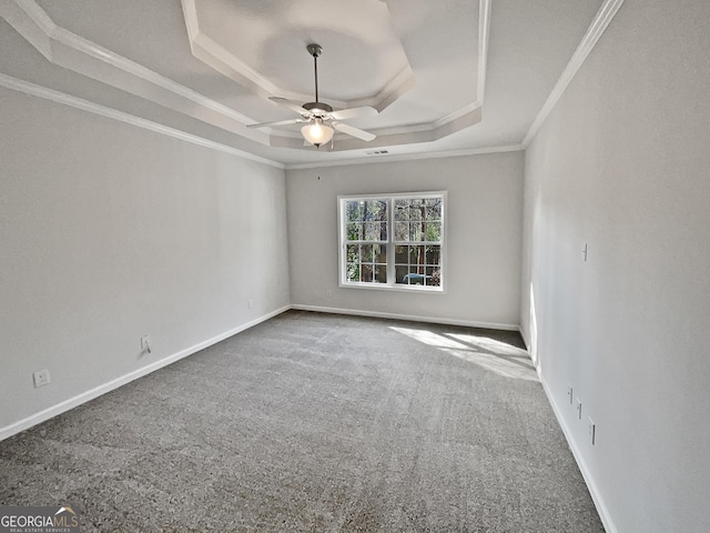 unfurnished room with carpet, a raised ceiling, ceiling fan, and crown molding