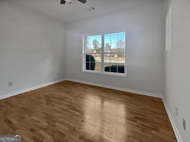 spare room with hardwood / wood-style flooring and ceiling fan