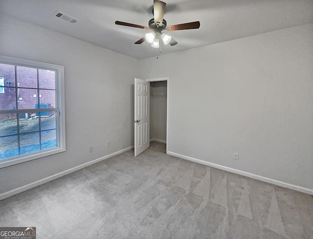 unfurnished bedroom featuring light carpet and ceiling fan