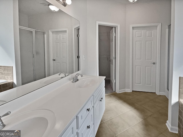 bathroom with tile patterned flooring, vanity, and separate shower and tub