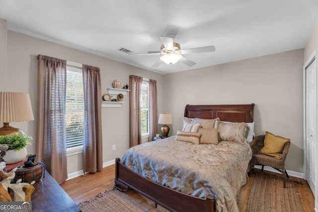 bedroom with ceiling fan, a closet, and light wood-type flooring