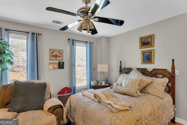 bedroom featuring multiple windows and ceiling fan