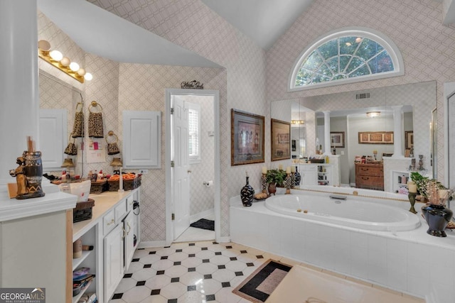 bathroom with vanity, vaulted ceiling, and separate shower and tub