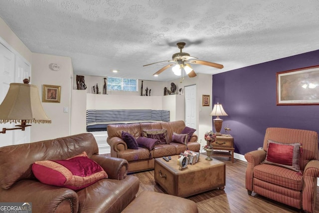 living room featuring hardwood / wood-style flooring and a textured ceiling