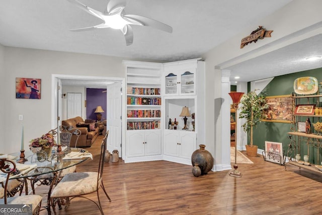 interior space with hardwood / wood-style floors, a textured ceiling, built in features, and ceiling fan