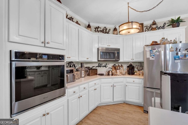 kitchen featuring light hardwood / wood-style flooring, appliances with stainless steel finishes, decorative light fixtures, white cabinets, and ornamental molding