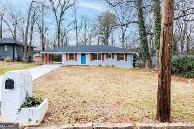 single story home featuring a front lawn and a carport