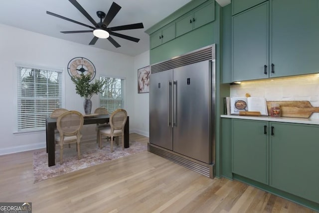 4492 Bryten Dr, Douglasville, GA 30135 - kitchen with green cabinetry, stainless steel built in fridge, and light wood finished floors