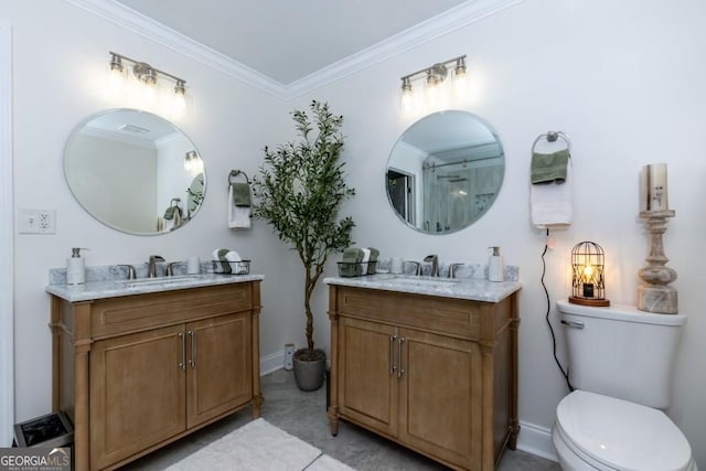 4492 Bryten Dr, Douglasville, GA 30135 - bathroom featuring two vanities, crown molding, toilet, and baseboards