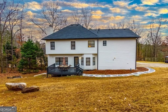 4492 Bryten Dr, Douglasville, GA 30135 - rear view of property with a deck, a lawn, a shingled roof, and a chimney