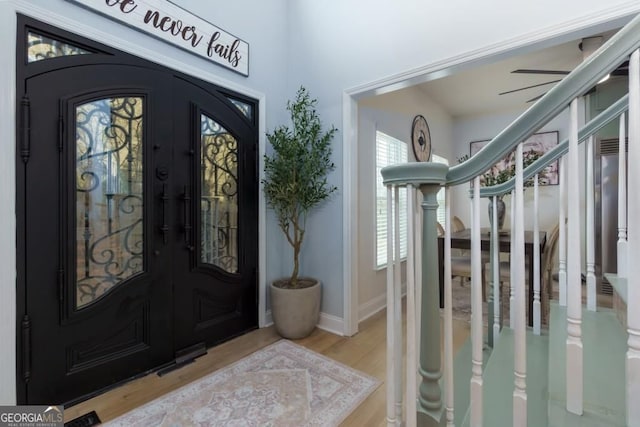 4492 Bryten Dr, Douglasville, GA 30135 - entryway featuring wood finished floors, stairs, baseboards, and french doors