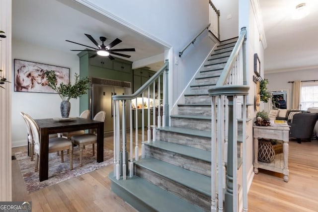 4492 Bryten Dr, Douglasville, GA 30135 - stairway featuring ceiling fan, wood finished floors, and ornamental molding