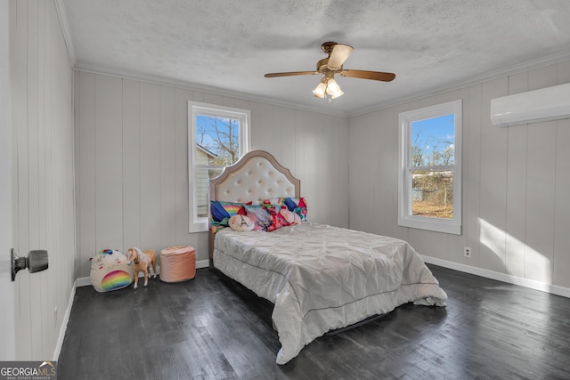 bedroom with dark hardwood / wood-style flooring, ornamental molding, an AC wall unit, and a textured ceiling