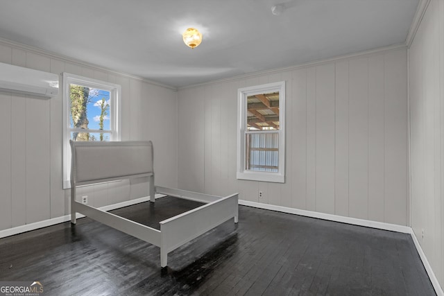 bedroom with ornamental molding, an AC wall unit, and dark wood-type flooring