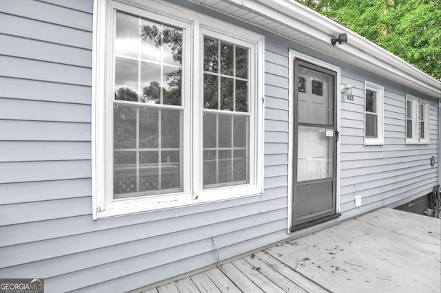 property entrance featuring a wooden deck