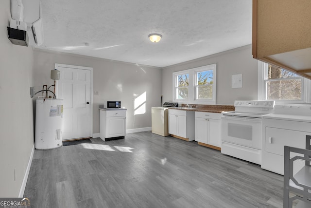 kitchen featuring water heater, white cabinetry, white range with electric stovetop, a textured ceiling, and washing machine and clothes dryer