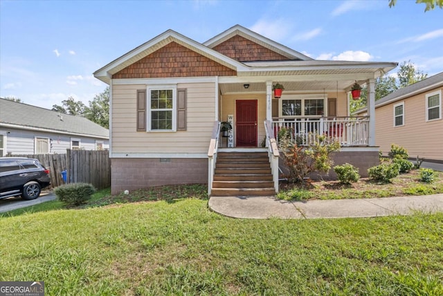 bungalow-style home with a porch and a front yard