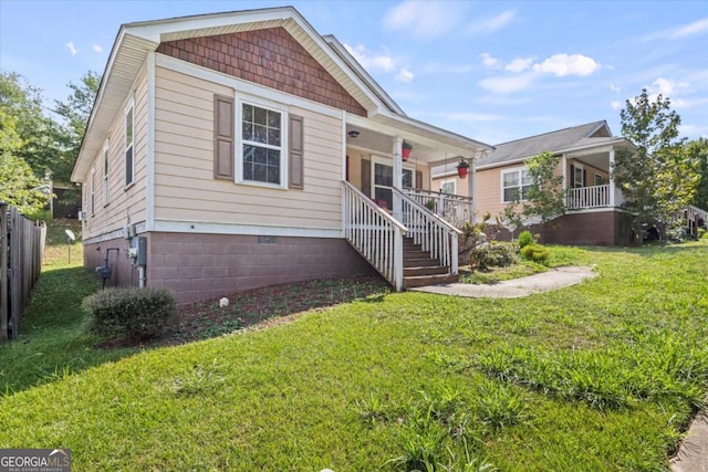 view of front facade featuring covered porch and a front yard