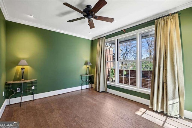 spare room featuring wood-type flooring, ceiling fan, and crown molding