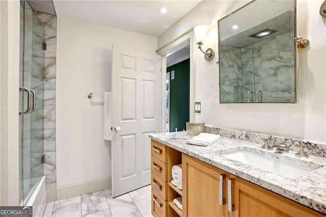 bathroom featuring vanity and a shower with door