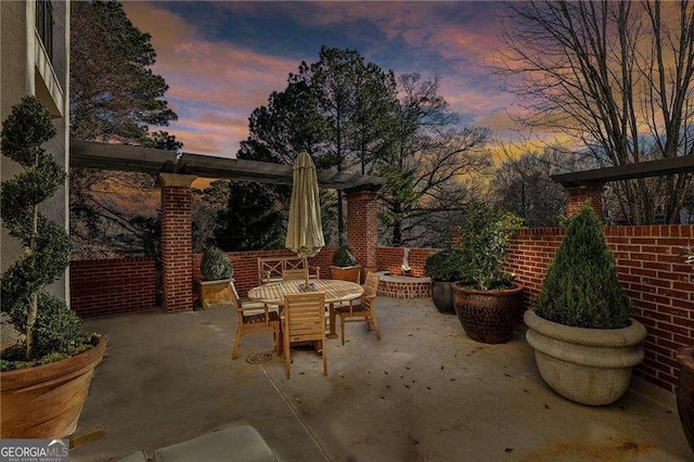 patio terrace at dusk featuring an outdoor fire pit