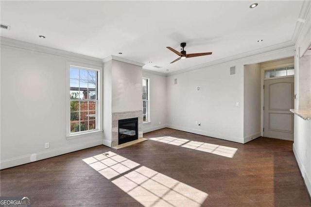 unfurnished living room featuring crown molding, ceiling fan, and dark wood-type flooring