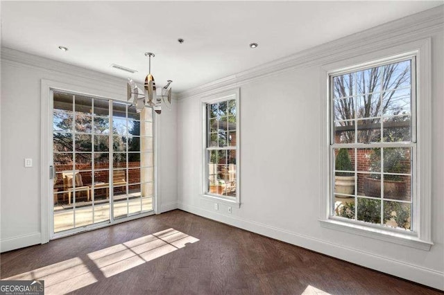 unfurnished dining area featuring a notable chandelier and crown molding