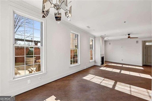 interior space with ceiling fan, a healthy amount of sunlight, and ornamental molding